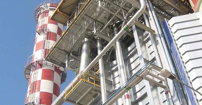 Photograph of an energy station with a checkered red and white tower on the left