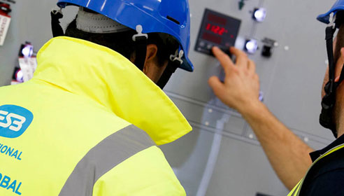 Man in safety gear inspecting machinery