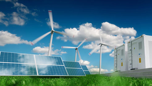 Photograph of solar panels with wind turbines in the background