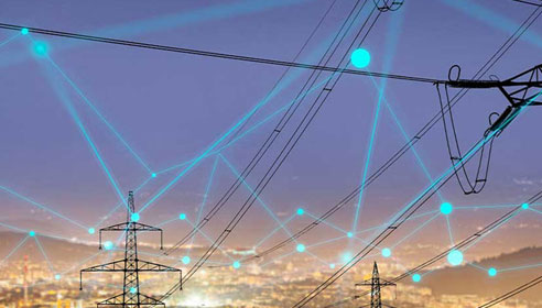 Image of pylons superimposed onto a blurred background of a city. There are lines and dots laid over the top of the image