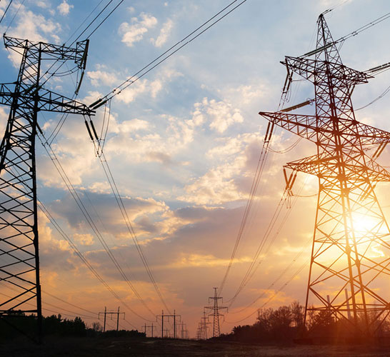 Image of electricity pylons with sunset in background