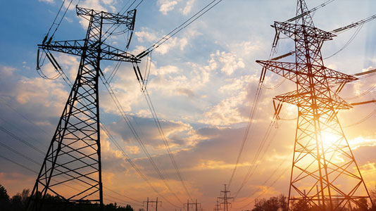 Image of electricity pylons with sunset in background