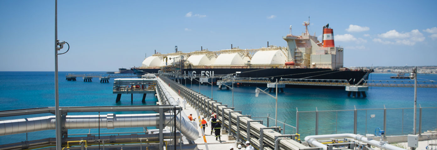 Photograph of a large ship docked next to a pier