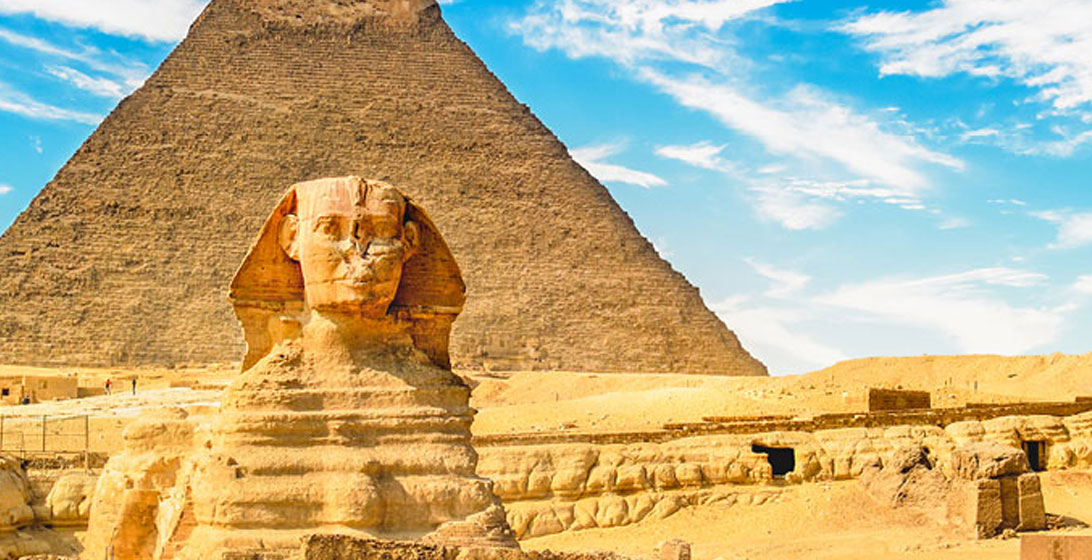 Photograph of the Great Sphinx of Giza in front of a pyramid